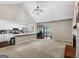 Open-concept living room and kitchen space with a brick fireplace and neutral color palette at 539 Horseshoe Cir, Stockbridge, GA 30281
