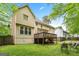 Expansive backyard with a wooden deck, lush green lawn, and privacy fencing, perfect for outdoor enjoyment at 10044 Point View Dr, Jonesboro, GA 30238