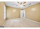 Comfortable carpeted bedroom with a ceiling fan, a window, and an open doorway to the rest of the house at 10044 Point View Dr, Jonesboro, GA 30238