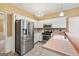 Kitchen featuring stainless steel appliances, white cabinets, mosaic tile backsplash, and chandelier at 10044 Point View Dr, Jonesboro, GA 30238