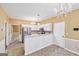 Bright eat-in kitchen with white cabinets, stainless steel appliances, and chandelier at 10044 Point View Dr, Jonesboro, GA 30238