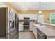 Bright kitchen featuring stainless steel appliances, mosaic tile backsplash, and chandelier at 10044 Point View Dr, Jonesboro, GA 30238