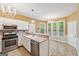 Open concept kitchen featuring stainless steel appliances and breakfast nook with natural lighting at 10044 Point View Dr, Jonesboro, GA 30238