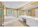 Main bathroom featuring double vanity and garden tub at 10044 Point View Dr, Jonesboro, GA 30238
