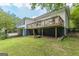 Backyard showing a wooden deck, fire pit, basement access and well-maintained lawn at 1493 Vesta Ave, Atlanta, GA 30337