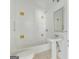 Cozy bathroom with white tiles, pedestal sink, tub and updated fixtures at 1493 Vesta Ave, Atlanta, GA 30337
