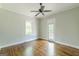 Bedroom with hardwood floors, a ceiling fan, and a glass door to the deck at 1493 Vesta Ave, Atlanta, GA 30337
