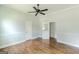Spacious bedroom featuring hardwood floors, a ceiling fan, and two entry doors at 1493 Vesta Ave, Atlanta, GA 30337