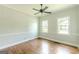 Cozy bedroom offers hardwood floors, a modern ceiling fan, and plenty of natural light at 1493 Vesta Ave, Atlanta, GA 30337