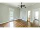 Bedroom with hardwood floors, a ceiling fan, and doorway to ensuite bath at 1493 Vesta Ave, Atlanta, GA 30337
