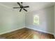 A clean and simple bedroom featuring hardwood floors, light-colored walls, and a ceiling fan at 1493 Vesta Ave, Atlanta, GA 30337