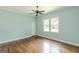 Bedroom featuring hardwood floors, a ceiling fan, a window, and a white door at 1493 Vesta Ave, Atlanta, GA 30337