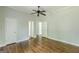 Bedroom featuring hardwood floors, ceiling fan, and multiple doorways at 1493 Vesta Ave, Atlanta, GA 30337