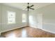 Light-filled bedroom features hardwood floors, neutral paint, and a ceiling fan at 1493 Vesta Ave, Atlanta, GA 30337