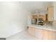 Bright dining area next to kitchen includes stainless steel appliances and light colored countertops at 1493 Vesta Ave, Atlanta, GA 30337