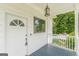 Inviting covered front porch featuring a decorative door and classic lighting fixture at 1493 Vesta Ave, Atlanta, GA 30337