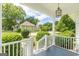 Inviting front porch with painted flooring, white railing and neighborhood views at 1493 Vesta Ave, Atlanta, GA 30337