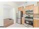 Spacious kitchen featuring stainless steel appliances and a seamless flow to the living and dining area at 1493 Vesta Ave, Atlanta, GA 30337