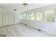 Bright living room with new floors, white walls and lots of windows looking out onto the yard at 1493 Vesta Ave, Atlanta, GA 30337
