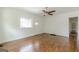 Bright living room featuring hardwood floors, a ceiling fan, and a window overlooking the front yard at 1493 Vesta Ave, Atlanta, GA 30337