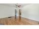 Living room featuring hardwood floors, ceiling fan and arched doorway leading into the kitchen at 1493 Vesta Ave, Atlanta, GA 30337