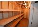 Unfinished basement space with insulated walls and installed wood shelving at 195 Twin Oaks Dr, Hampton, GA 30228