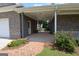 Covered carport with brick columns, accessible doorway, and lush landscaping at 195 Twin Oaks Dr, Hampton, GA 30228