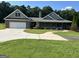 Beautiful single-story home with a large driveway, attached garage, and inviting front porch at 195 Twin Oaks Dr, Hampton, GA 30228