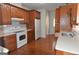 A well-lit kitchen features wood cabinets, white countertops, modern appliances, and hardwood flooring at 195 Twin Oaks Dr, Hampton, GA 30228