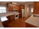 Well-equipped kitchen with wood cabinets, white appliances, and sleek countertops at 195 Twin Oaks Dr, Hampton, GA 30228