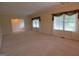 Open-concept living room with carpet, decorative windows, and neutral color palette at 195 Twin Oaks Dr, Hampton, GA 30228