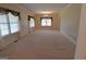 Bright and spacious living room with neutral carpet, crown molding, and natural light at 195 Twin Oaks Dr, Hampton, GA 30228