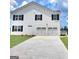 This gorgeous home features a two car garage and large driveway perfect for multiple car parking at 363 Friendship Oak Way, Hampton, GA 30228