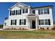 Stately two-story home featuring white siding, black shutters, and a welcoming front porch at 363 Friendship Oak Way, Hampton, GA 30228