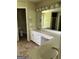 Bright bathroom featuring a double vanity, mirrors, and tile flooring at 4887 Winterview Ln, Douglasville, GA 30135