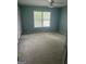 Bedroom with neutral carpet, a ceiling fan, and a large window overlooking the yard at 4887 Winterview Ln, Douglasville, GA 30135