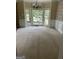 Elegant dining room with carpet, large windows, and decorative chandelier at 4887 Winterview Ln, Douglasville, GA 30135