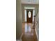Sunlit foyer with hardwood floors and a decorative front door at 4887 Winterview Ln, Douglasville, GA 30135
