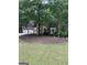 Charming brick home featuring a two-car garage and mature landscaping at 4887 Winterview Ln, Douglasville, GA 30135
