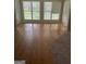 Bright living room with hardwood floors, large windows, and a door to the outside at 4887 Winterview Ln, Douglasville, GA 30135