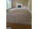 Carpeted living room featuring a fireplace, a large window, and neutral walls at 4887 Winterview Ln, Douglasville, GA 30135