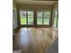 Sunlit living room featuring hardwood floors, a wall of windows with green views at 4887 Winterview Ln, Douglasville, GA 30135