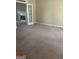 Carpeted living room featuring a fireplace, a large window, and neutral walls at 4887 Winterview Ln, Douglasville, GA 30135