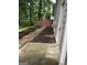Side yard with mulch beds, a stone path, and a view of the backyard fence at 4887 Winterview Ln, Douglasville, GA 30135
