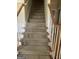 Carpeted staircase featuring a stained wood handrail at 4887 Winterview Ln, Douglasville, GA 30135