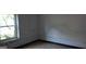 Bedroom with bare walls, baseboard damage and a window showing exterior plants at 2138 Rachael Se St, Atlanta, GA 30315
