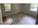 Bedroom with new floors, gray walls and two windows that provide ample natural light at 2138 Rachael Se St, Atlanta, GA 30315
