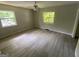 Bedroom featuring new floors, a ceiling fan and two windows for natural light at 2138 Rachael Se St, Atlanta, GA 30315