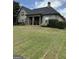 Home's backyard has a covered patio area and a large grassy area at 6409 Caledon Ct, Locust Grove, GA 30248