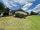 The back of the house is brick with a covered patio and a large backyard, perfect for outdoor activities at 6409 Caledon Ct, Locust Grove, GA 30248